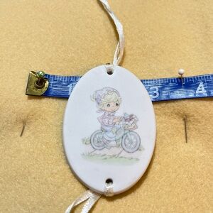 Precious Moments White Oval Pendant with Biking Design